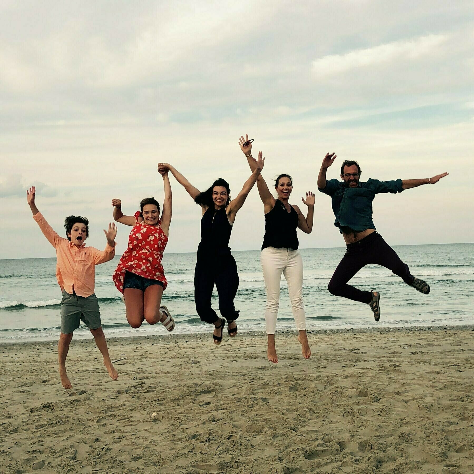 Zuiker Family jumping at the beach