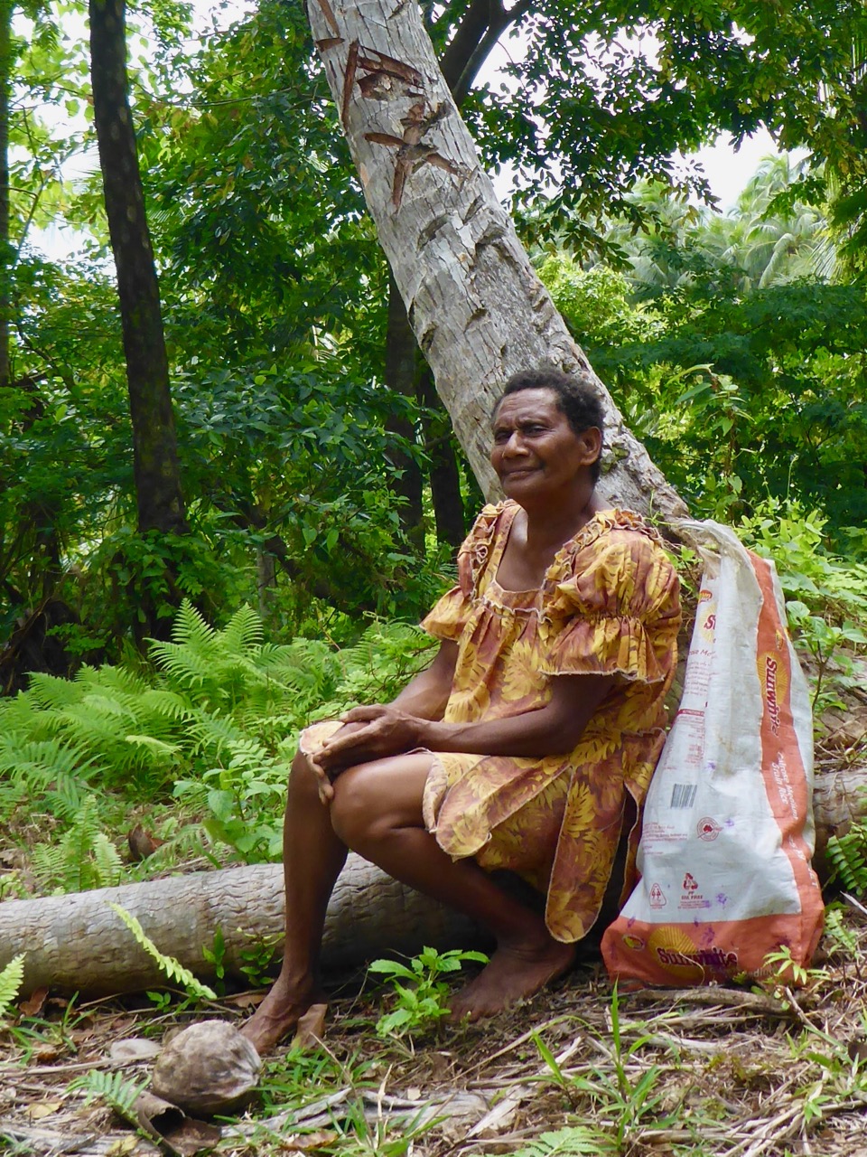 Leah sitting against a coconut tree